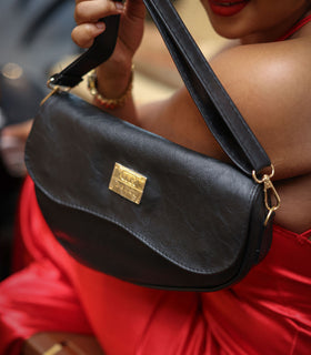 Denri Africa's black Montana Sling Bag. Sleek black sling purse, minimalist look, casual daily carry