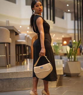 Denri Africa's beige Montana Sling Bag. Beige compact sling bag, vegan leather, versatile everyday accessory.
