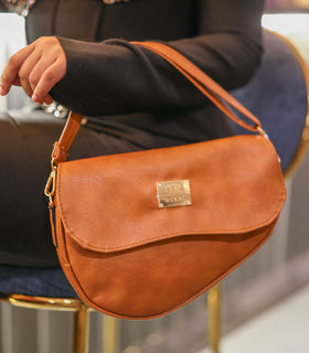 Denri Africa's spice Montana Sling Bag. Stylish spice-tone sling purse, durable vegan leather build.
