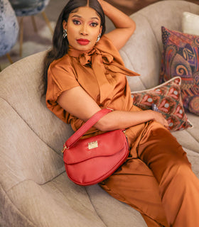 Denri Africa's red Montana Sling Bag. Stylish red sling purse, lightweight vegan leather carry bag, daily wear accessory.