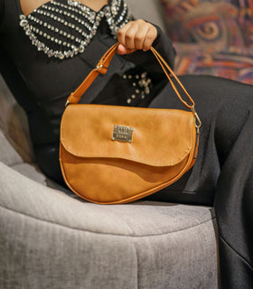 Denri Africa's beige Montana Sling Bag. Everyday beige crossbody, simple and modern, vegan leather style.