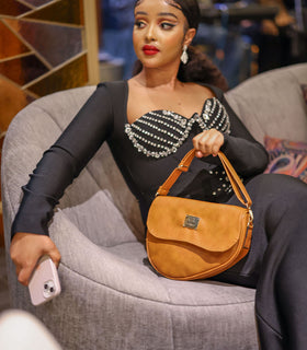 Denri Africa's beige Montana Sling Bag. Neutral-tone sling purse, minimalist vegan leather, everyday casual wear.