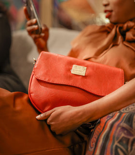 Denri Africa's red Montana Sling Bag. Compact crossbody sling, bold vegan leather design, everyday essentials bag.