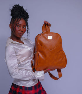 Denri Africa's caramel Monah Backpack. Earth-tone caramel backpack, rugged fabric, great for daily commuting or outdoor use.