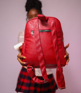 Denri Africa's red Monah Backpack. Red student backpack, water‑resistant fabric, practical for books, laptop or daily essentials.