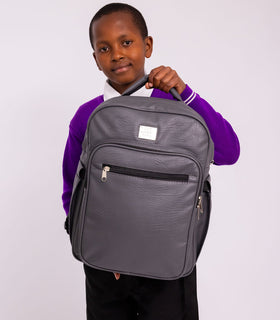 Denri Africa's gray Pioneer Backpack. Grey laptop-compatible backpack, padded shoulder straps, durable school/work bag.