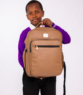 Denri Africa's beige Pioneer Backpack. Minimalist beige backpack, comfortable straps, great for school or work essentials.