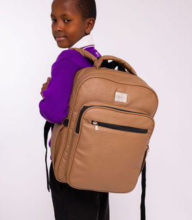 Denri Africa's beige Pioneer Backpack. Light beige school backpack, durable build, ideal for daily commute or travel.