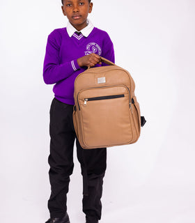 Denri Africa's beige Pioneer Backpack. Neutral beige school backpack, light-toned fabric, clean minimalist style.