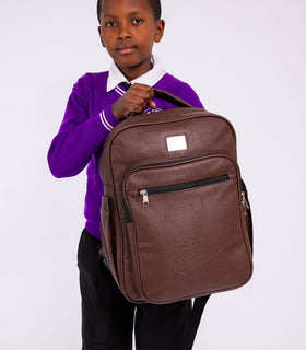 Denri Africa's brown Pioneer Backpack. Brown versatile backpack, padded laptop sleeve, secure zippers, everyday use.