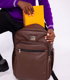 Denri Africa's brown Pioneer Backpack. Earth-tone brown backpack, rugged fabric, suitable for commuting or travel.