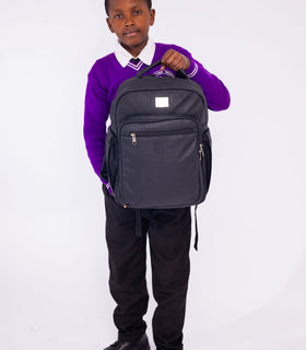 Denri Africa's black Pioneer Backpack. Black minimal backpack, sleek design, padded compartments for laptop and books.