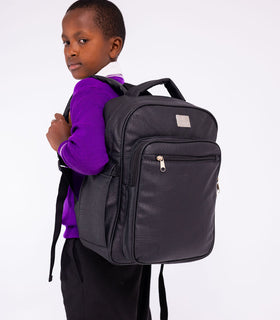 Denri Africa's black Pioneer Backpack. Black classic backpack, roomy interior, water-resistant exterior, everyday carry.