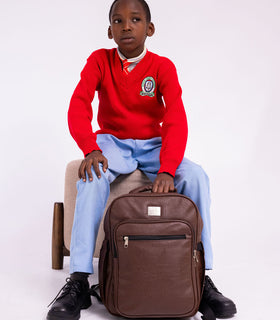 Denri Africa's brown Pioneer Backpack. Classic brown school backpack, roomy interior, durable everyday bag.