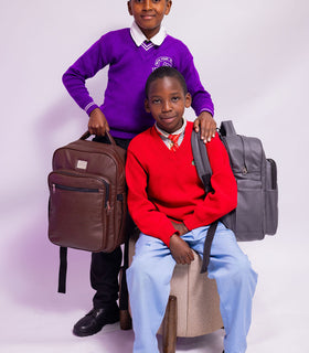 Denri Africa's brown and gray Pioneer Backpack pair. Dual-color backpack display, durable fabric, versatile school or travel pack.