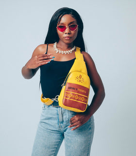 Denri Africa’s yellow Denri x Manyatta Crossbody Bag. Bright vegan-leather crossbody sling, slim profile bag, stylish statement carry.