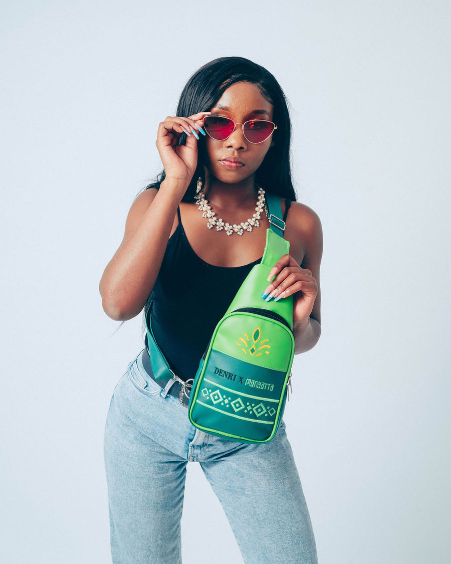 Denri Africa’s green Denri x Manyatta Crossbody Bag. Slim crossbody bag, deep green finish, practical hands-free carry for daily essentials.