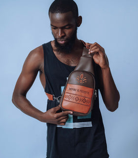 Denri Africa’s brown Denri x Manyatta Crossbody Bag. Slim vegan-leather chest bag, compact everyday carry, rich brown finish.